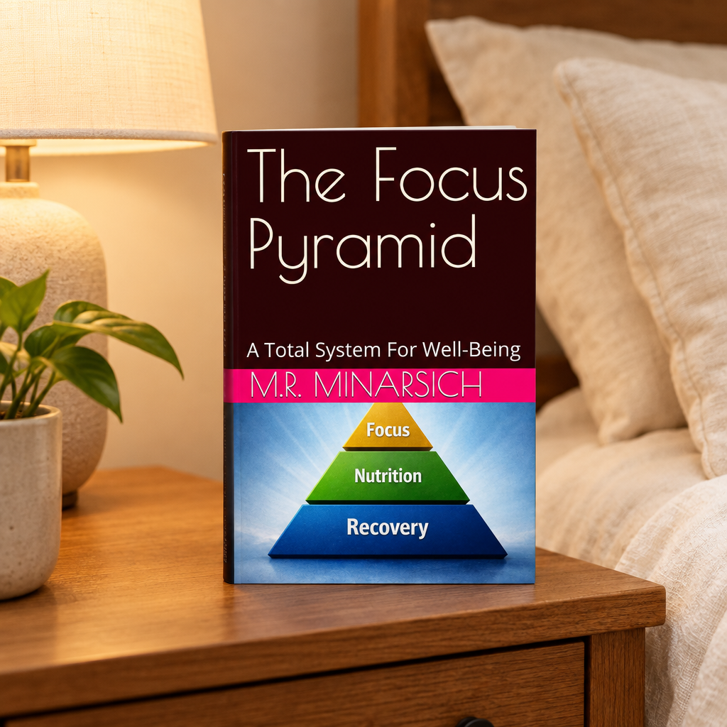 The Focus Pyramid book displayed on a nightstand beside a lamp